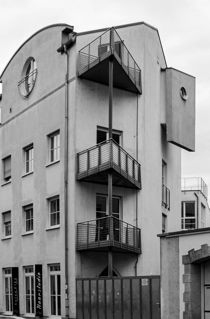 schwarzweiß Foto von einem Gebäude mit Spitzbalkonen