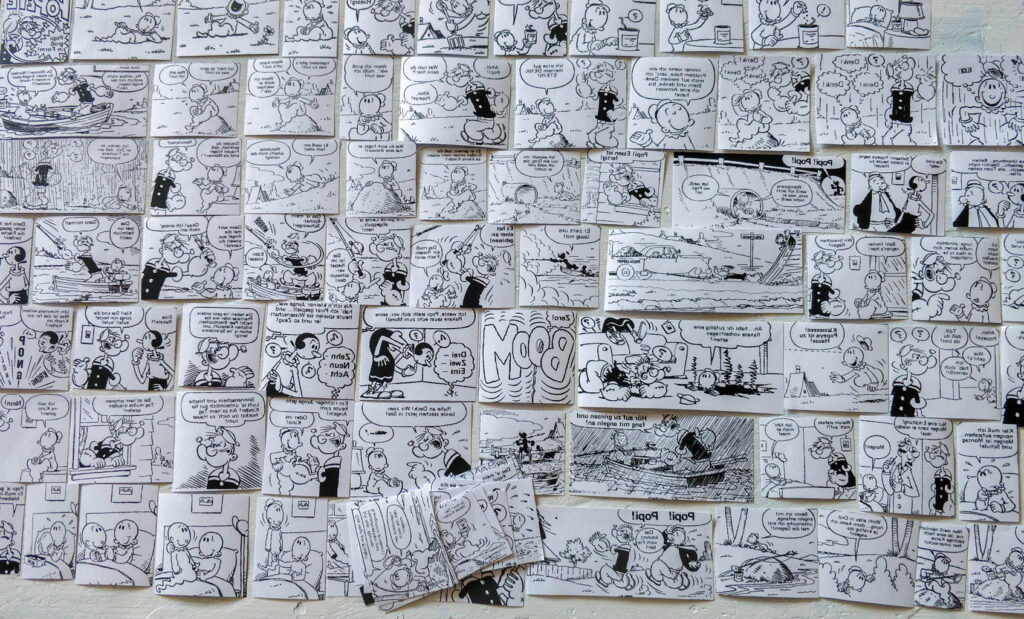 Popeye-Comicteile schwarzweiß auf Tischplatte zur Kontrolle aufgelegt